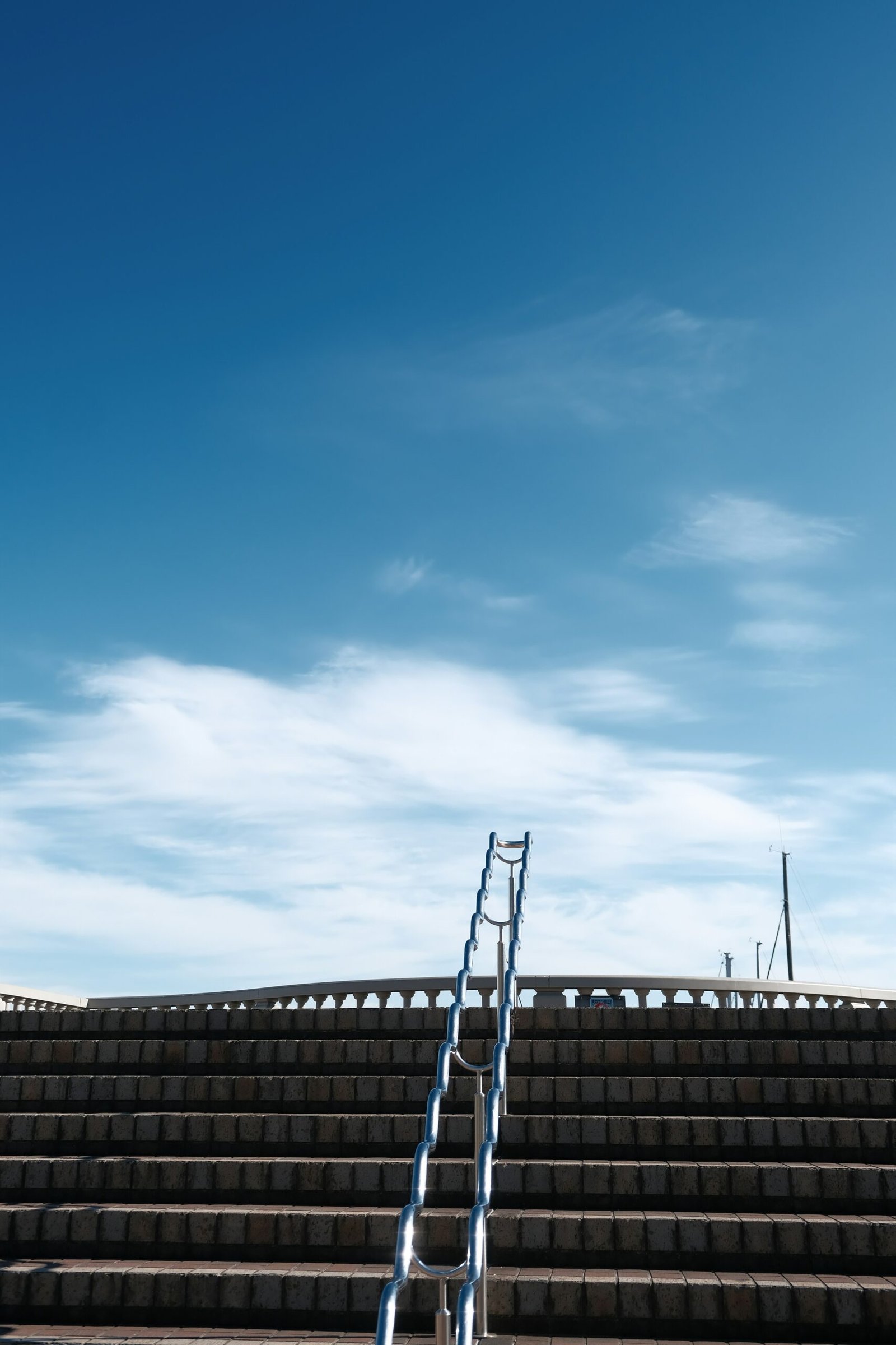 a set of steps leading up to a sky filled with clouds